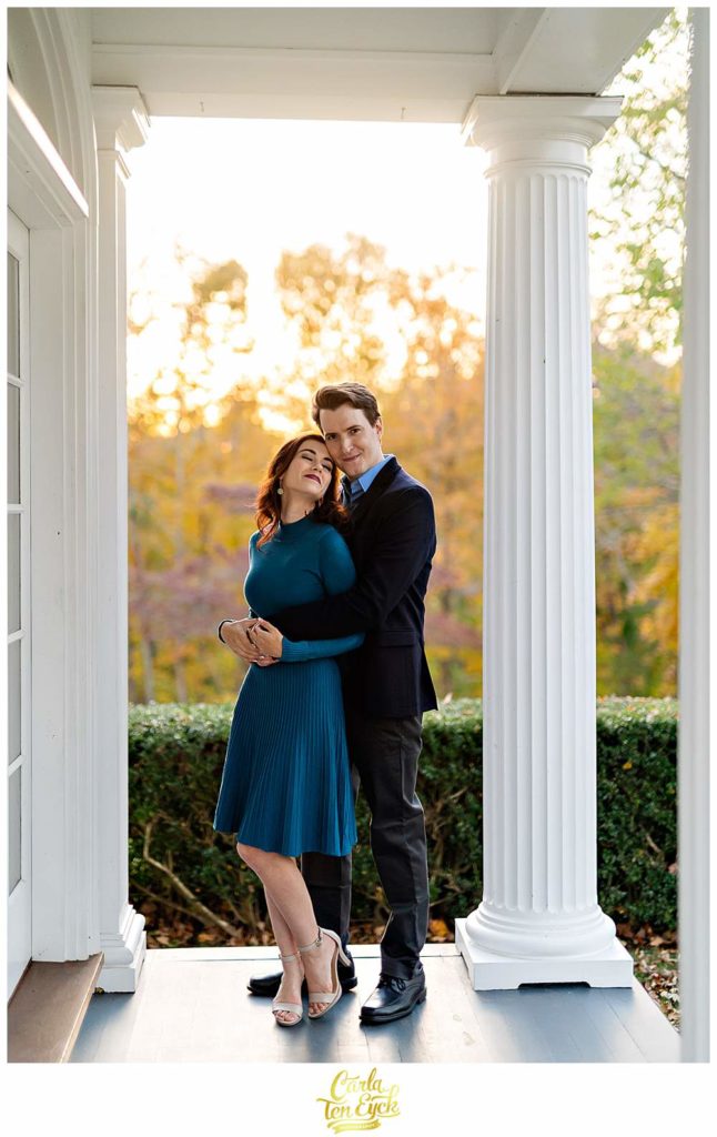 A couple snuggles during their engagement session at Smith Farm Gardens in East Haddam CT