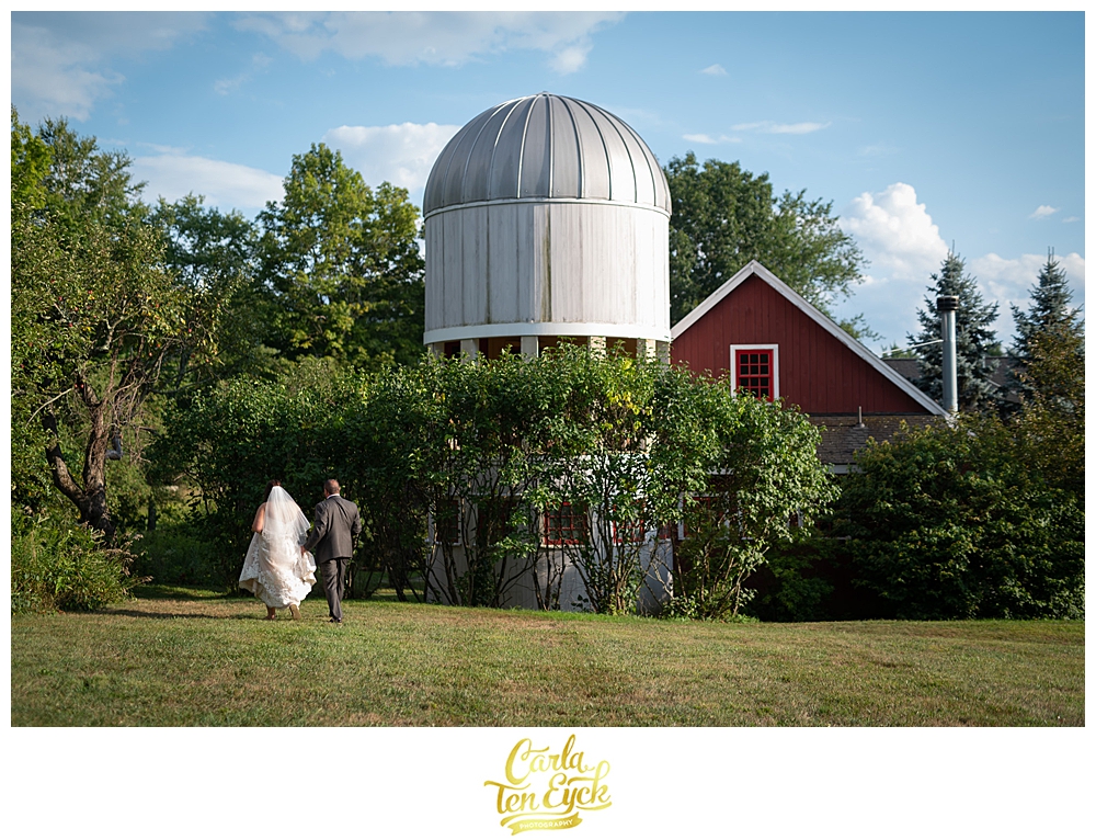 A bride and groom walk to the Charter Oak Suite at their intimate Winvian Wedding in Morris CT