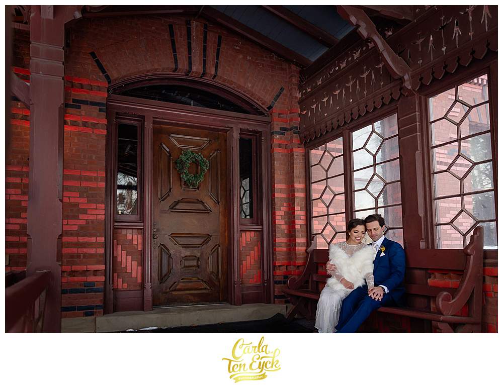 A couple embraces on the porch on their wedding day at The Mark Twain House in Hartford CT