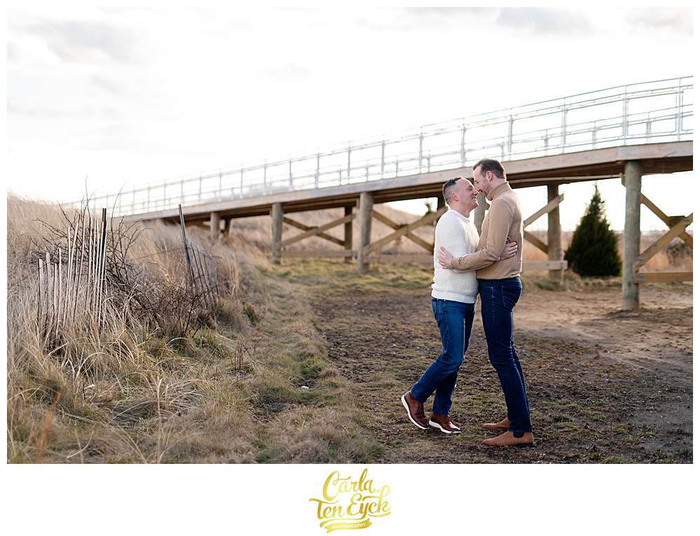 Two grooms during their winter engagement session at Silver Sands beach in Milford CT