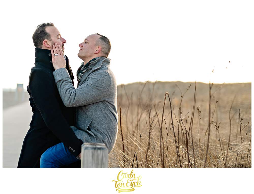 Two grooms during their winter beach engagement session at Silver Sands beach in Milford CT