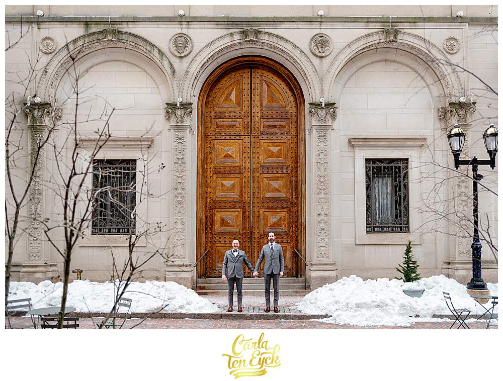 Two grooms pose for photos outside of the Society Room on their way to Hartford City Hall