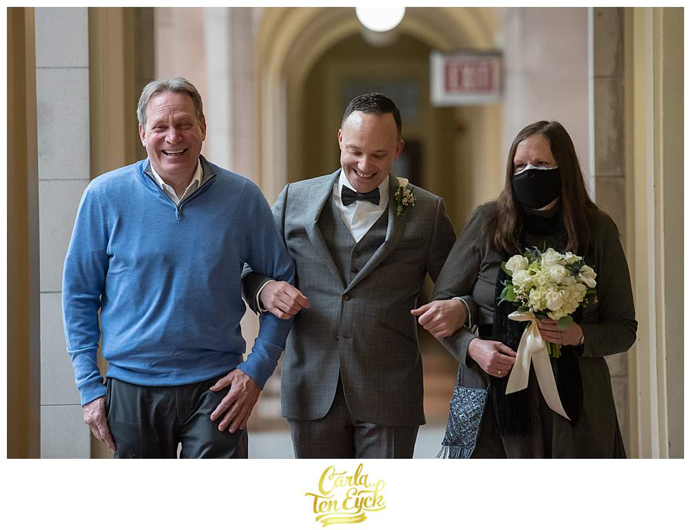 A groom walks down the aisle during his Hartford City Hall elopement in Hartford CT