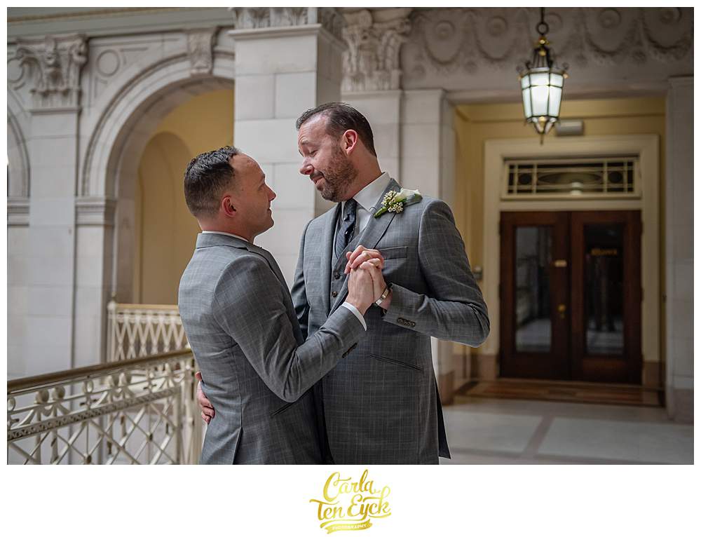 Two grooms dance during their elopement at Hartford City Hall