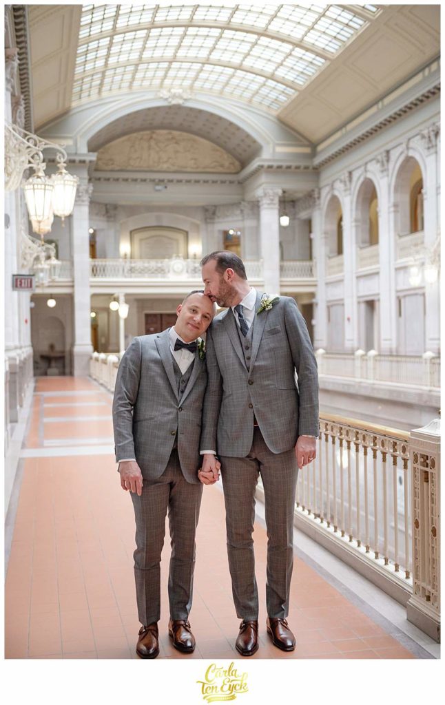 Two grooms kiss at Hartford City Hall at their elopement in Hartford CT