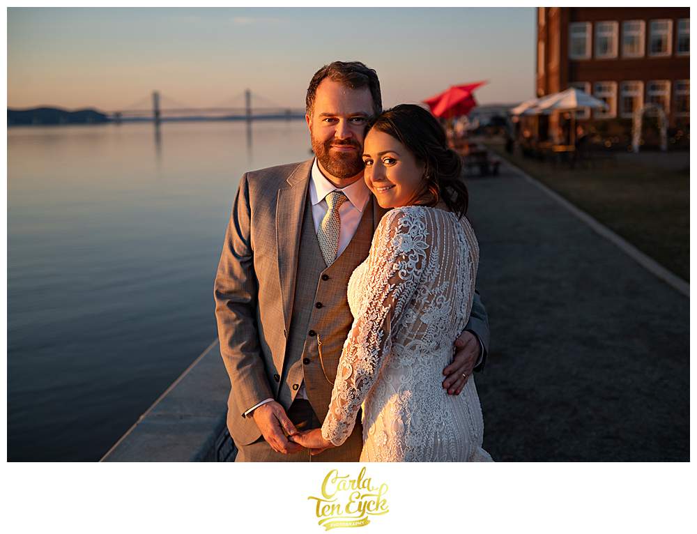 A bride and groom pose for photos at their wedding at Red Hat on the River in Irvington NY