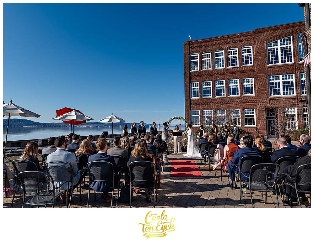 Wedding ceremony at Red Hat on the River Irvington NY on a sunny day