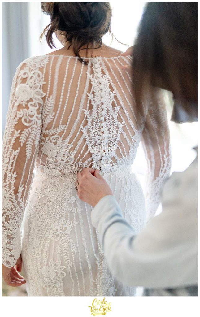 A bride puts on her wedding gown designed by Pronovias