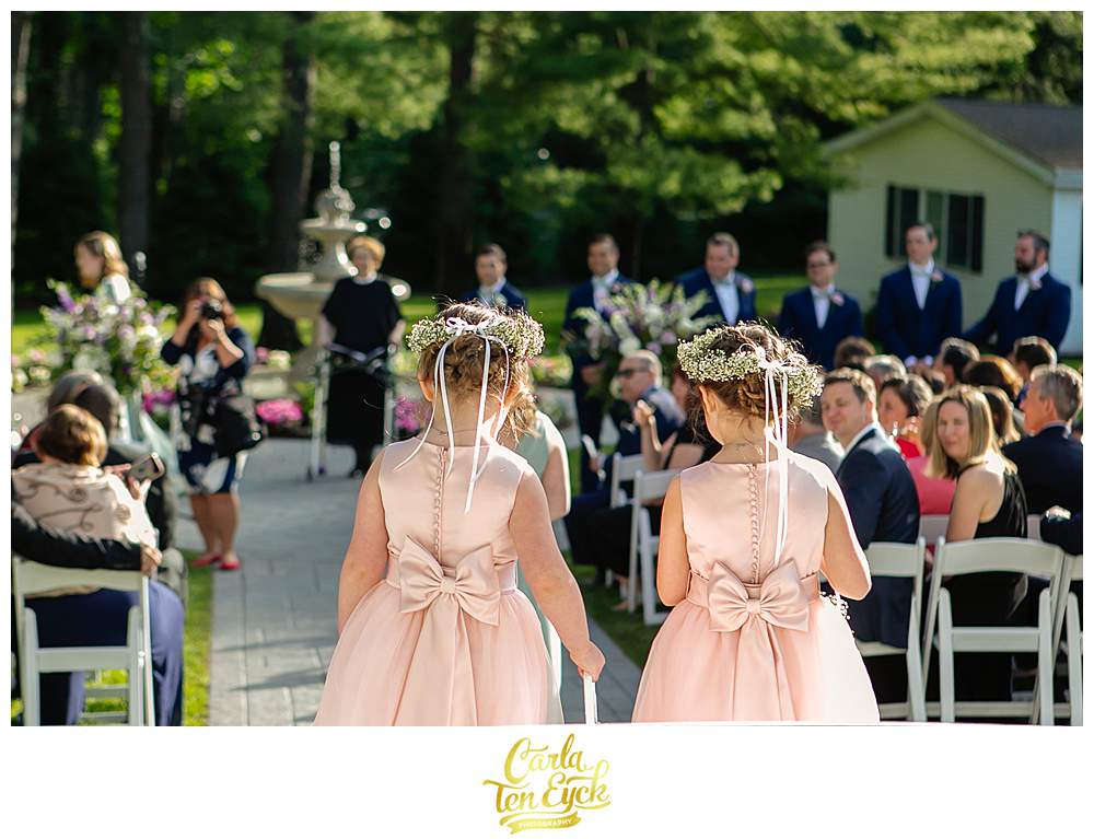 Two flower girls walk down the aisle at a Fox Hill Inn Wedding at Brookfield CT