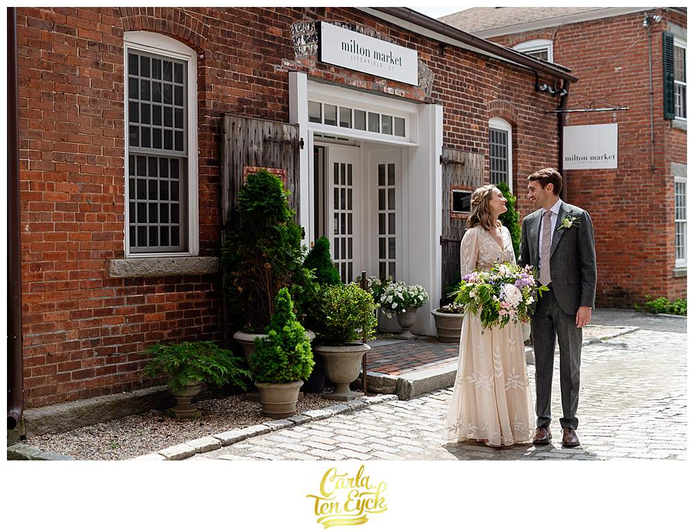 A couple poses for photos on a cobblestone street at their Litchfield wedding, Litchfield CT