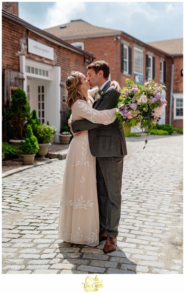 A bride and groom kiss on a cobblestone street during their Litchfield wedding, Litchfield CT