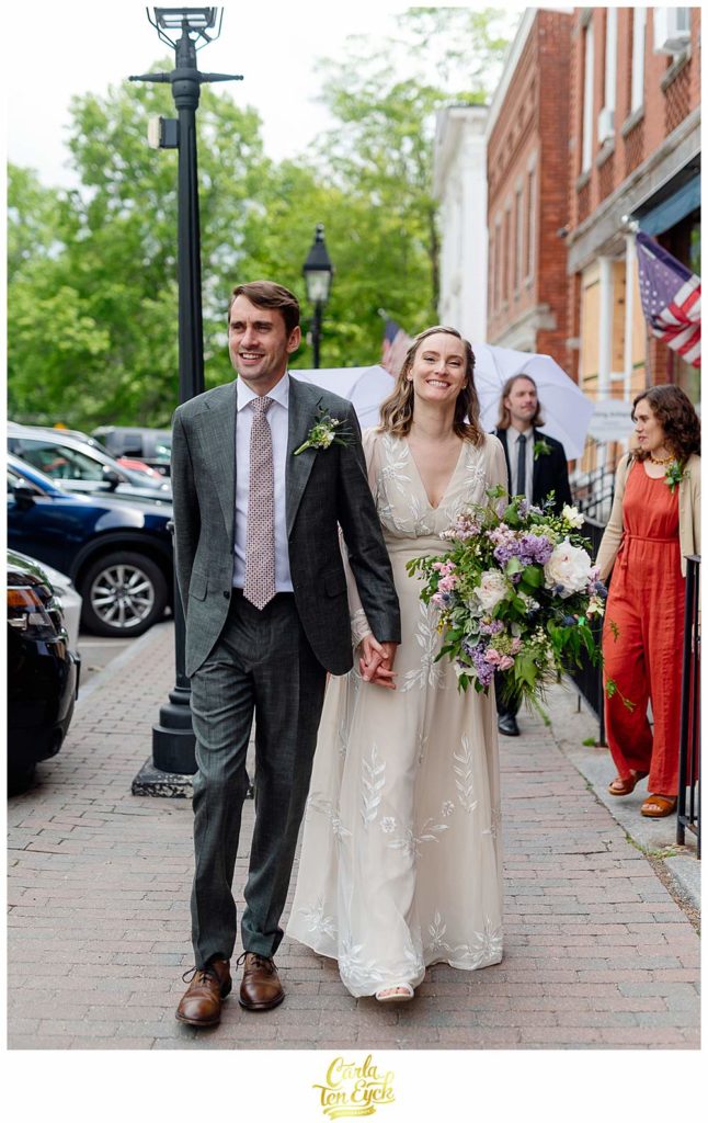 A bride and groom walk down the street during their Litchfield wedding, Litchfield CT