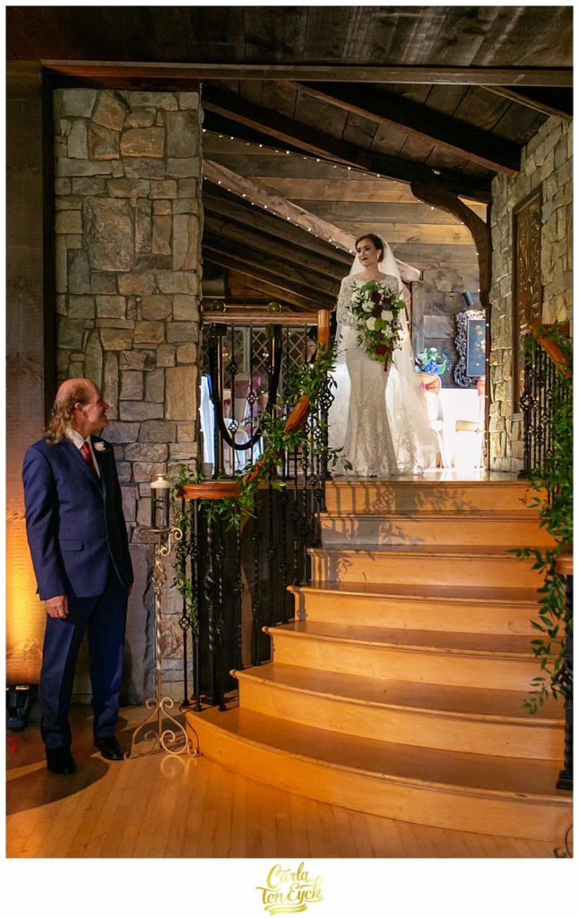 A bride waits to walk down the stairs at her Bill Miller's Castle Wedding in Branford CT