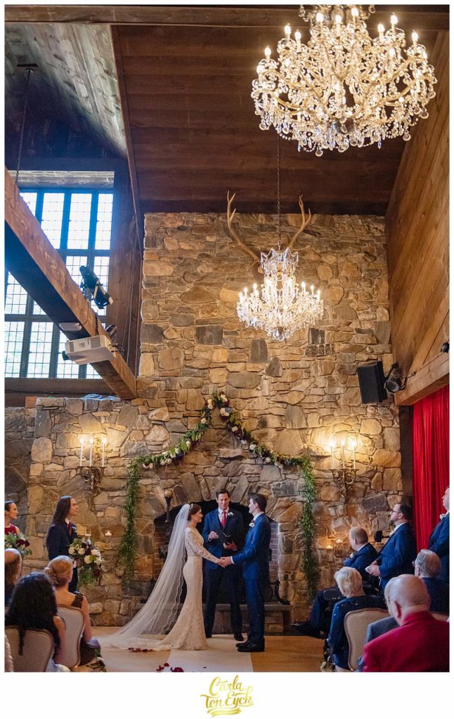 A bride and groom during their wedding ceremony at their Bill Miller's Castle wedding in Branford CT