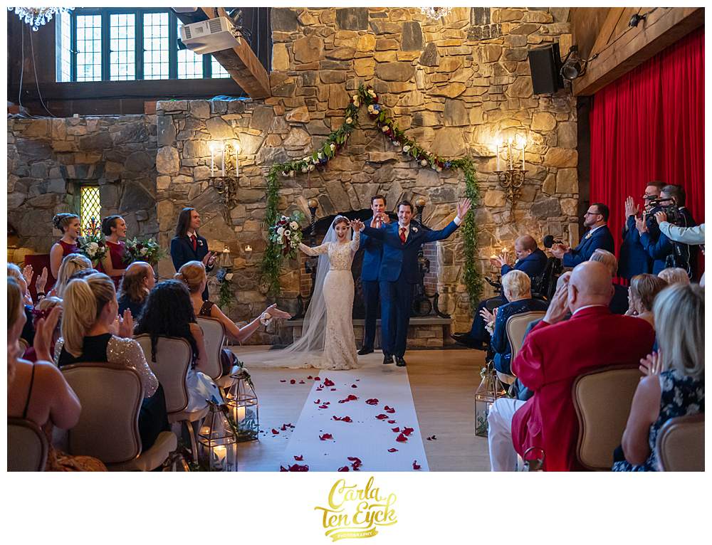 A couple celebrates after getting married at their Bill Miller's Castle wedding in Branford CT