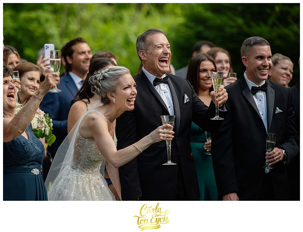 A couple laughs during toasts at their Lord Thompson Manor wedding in Thompson CT