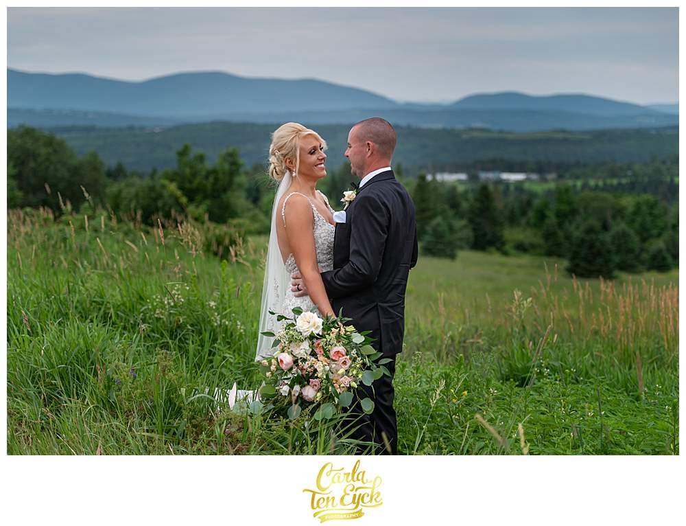 A bride and groom laugh during their New Hampshire wedding