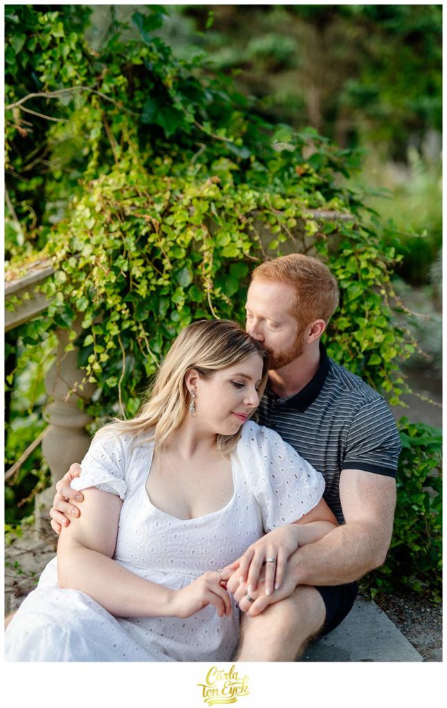 A couple cuddles on the stairs at Harkness for their engagement session in Waterford CT
