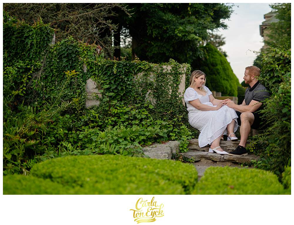 A bride and groom pose in a nook at Harkness during their wedding photos at Harkness Park in Waterford CT