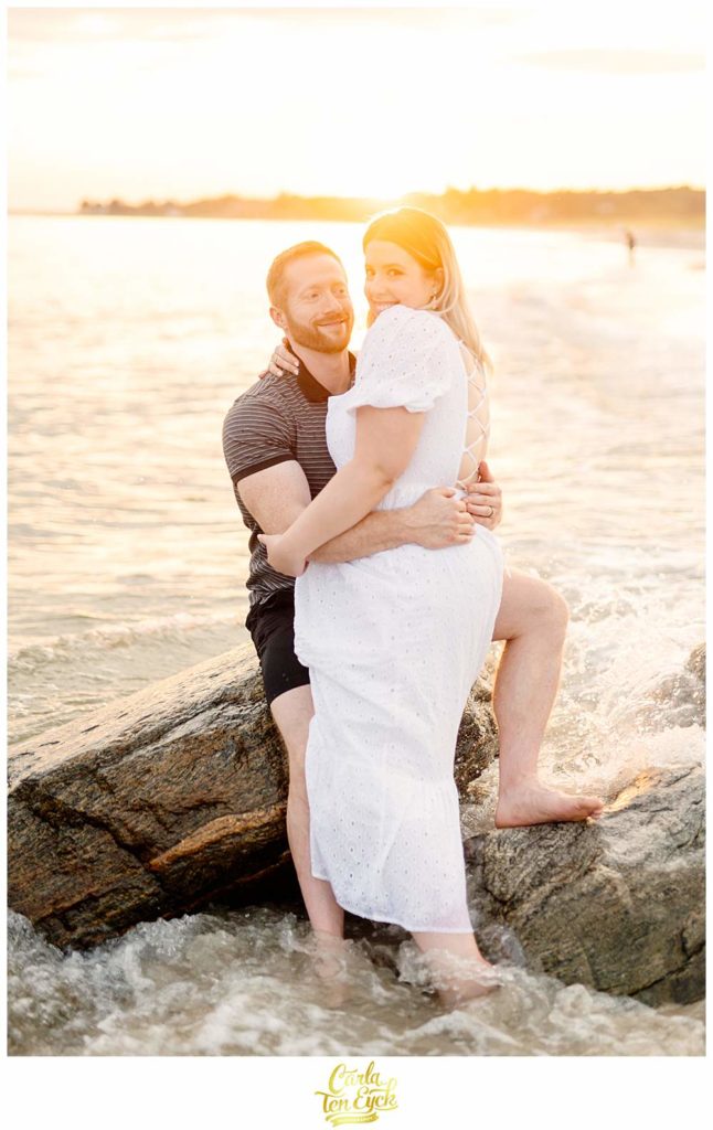 A couple frolics in the waves at Harkness during their summer engagement session at Harkness Park in Waterford CT