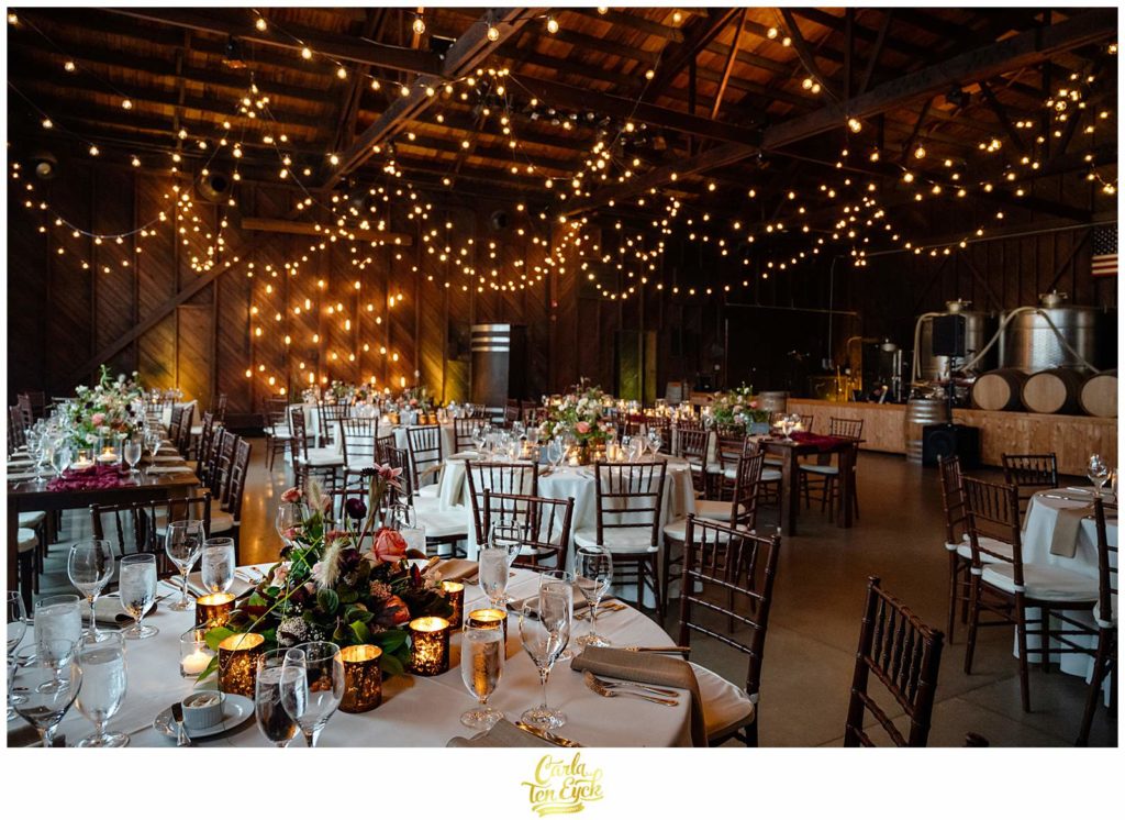 The reception room glows at the autumn Saltwater Farm Vineyard wedding in Stonington CT