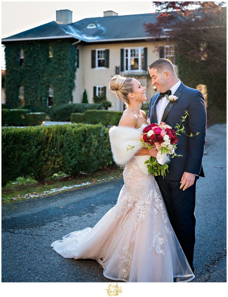 A bride and groom during their first look at their winter Lord Thompson Manor wedding in Thompson CT