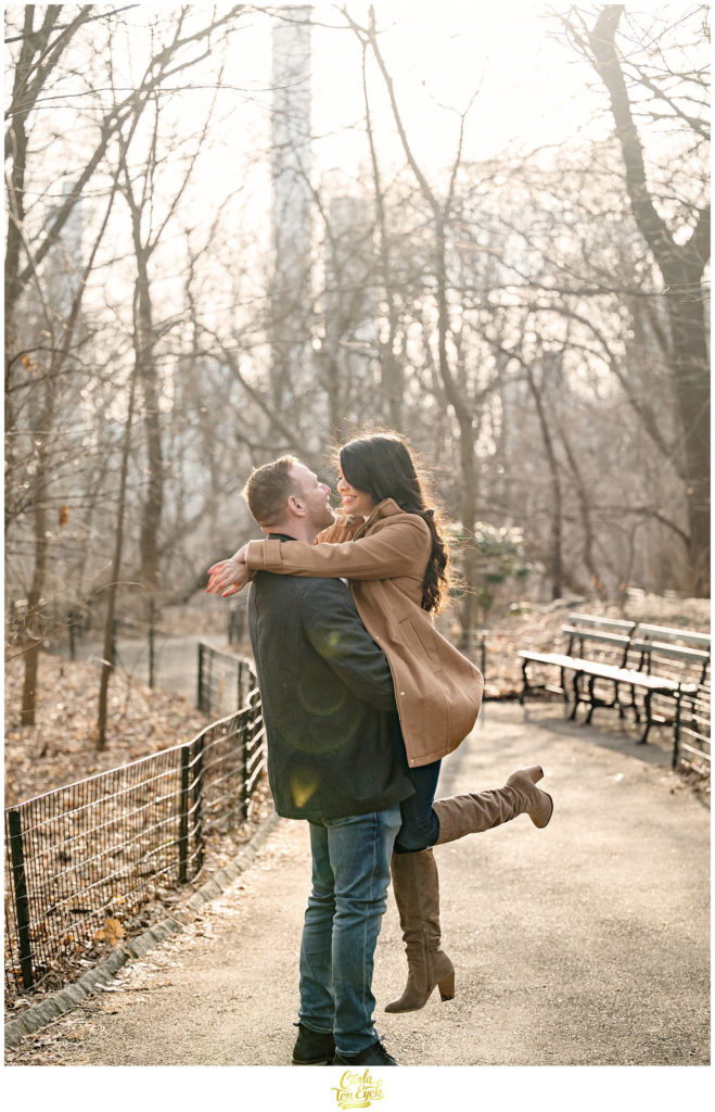 A couple poses for their winter engagement session in The Ramble in Central Park in NYC