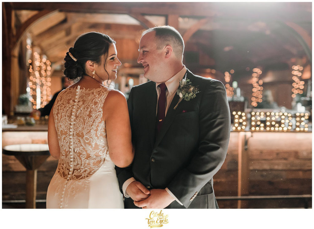 A bride and groom cuddle at their wedding at The Barns at Wesleyan Hills in Middletown CT