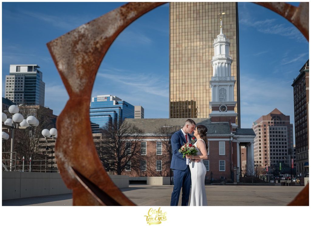 A bride and groom kiss during their Hartford City Hall Spring elopement, in Hartford CT