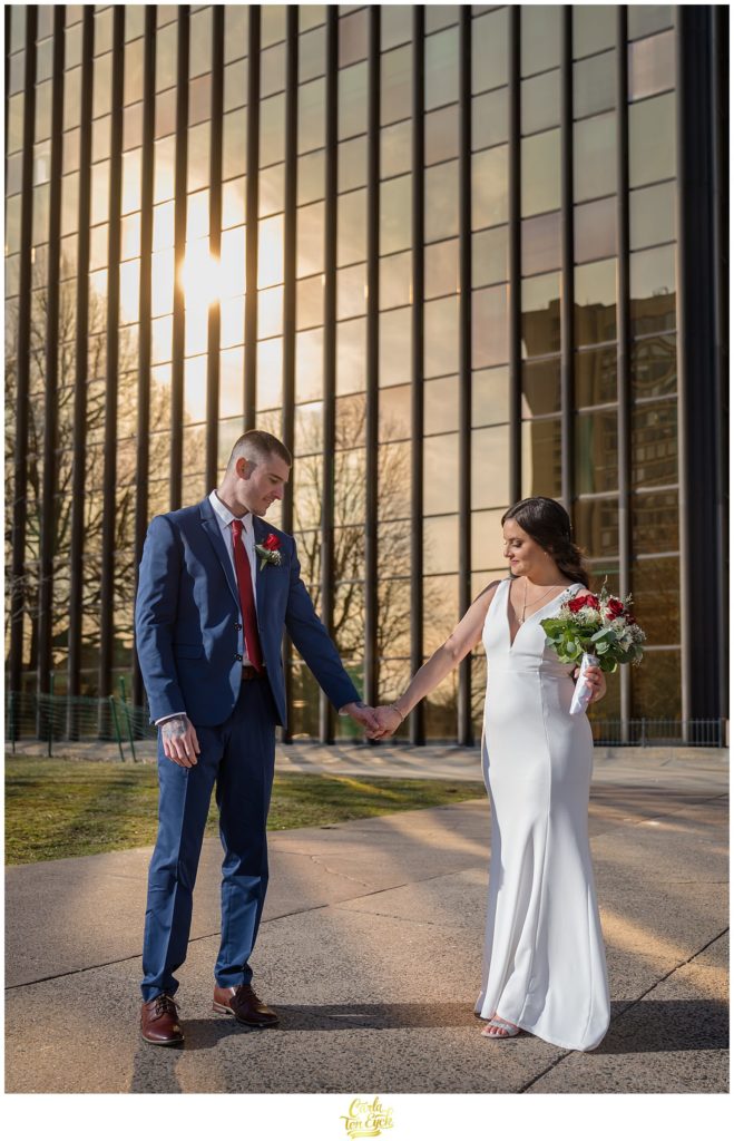 The Gold Building in Hartford sparkles behind a couple during their Hartford City Hall Spring elopement, in Hartford CT