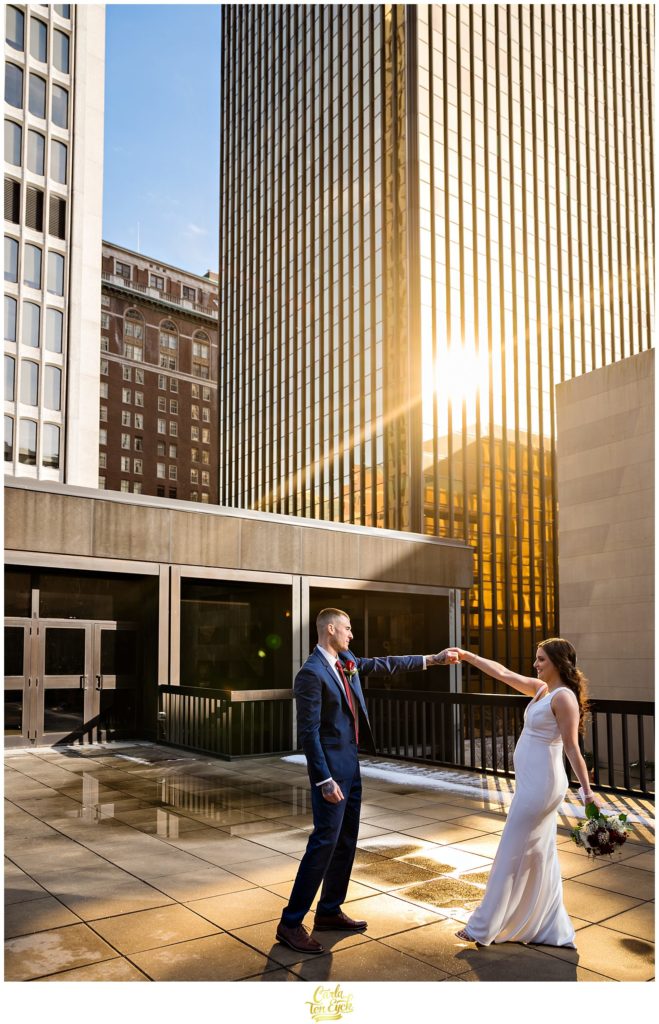 A couple dances on a rooftop during their Hartford City Hall Spring elopement, in Hartford CT