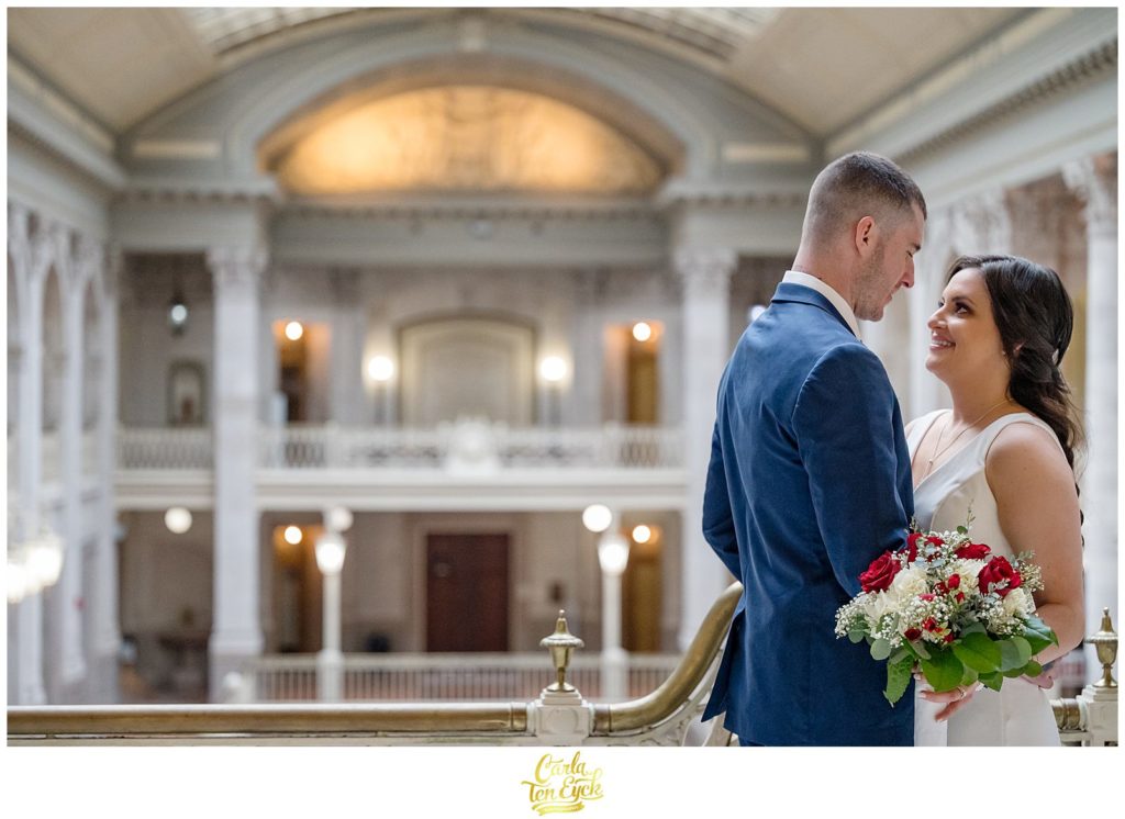 A bride and groom pose for their wedding photos at their Hartford City Hall Spring elopement, in Hartford CT