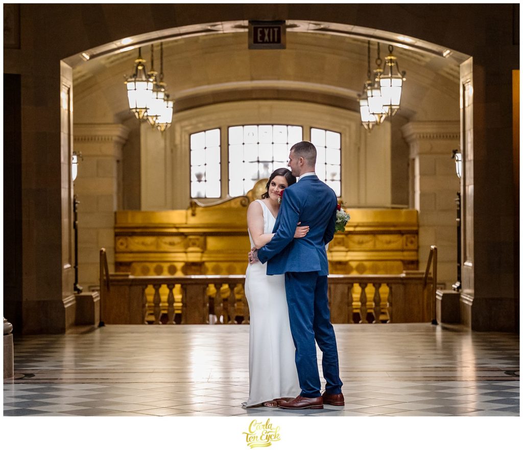 A bride and groom pose for photos at their Hartford City Hall Spring elopement, in Hartford CT