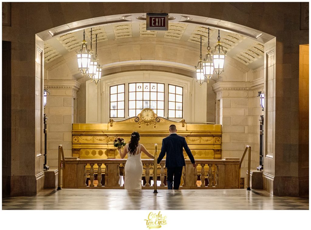 A bride and groom hold hands at their Hartford City Hall Spring elopement, in Hartford CT