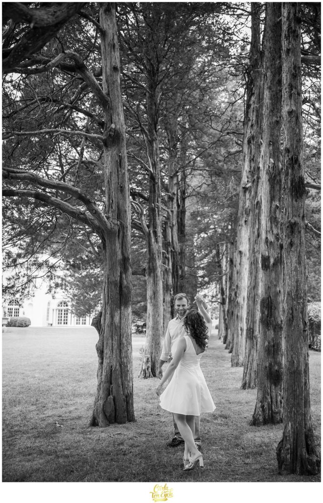 A couple dances in the grove of trees during their Wadsworth Mansion Engagement session in Middletown CT