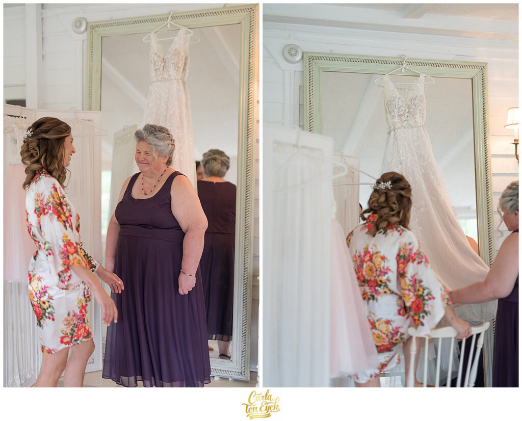 A bride and her Mom look at her wedding gown at her Lord Thompson Manor wedding