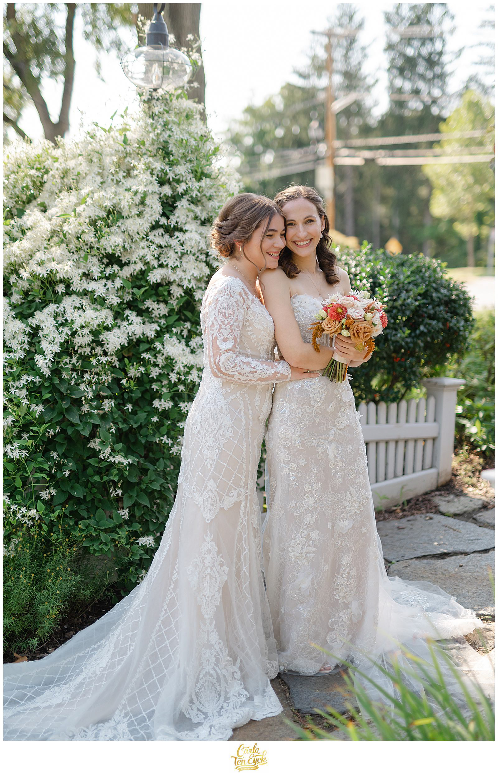 Two brides pose for their wedding photos and laugh at The Log Cabin Holyoke MA