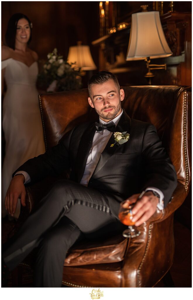 A groom poses for photos at his wedding at Lord Thompson Manor in Thompson CT
