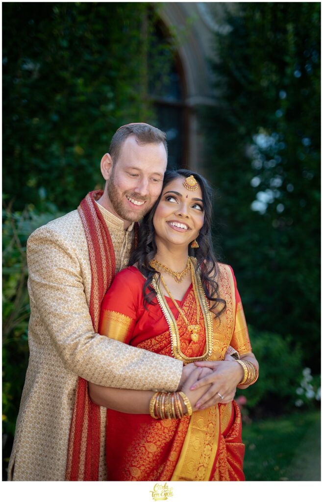A hindu bride and jewish groom cuddle for photos during their wedding at the VIP Country Club in New Rochelle NY