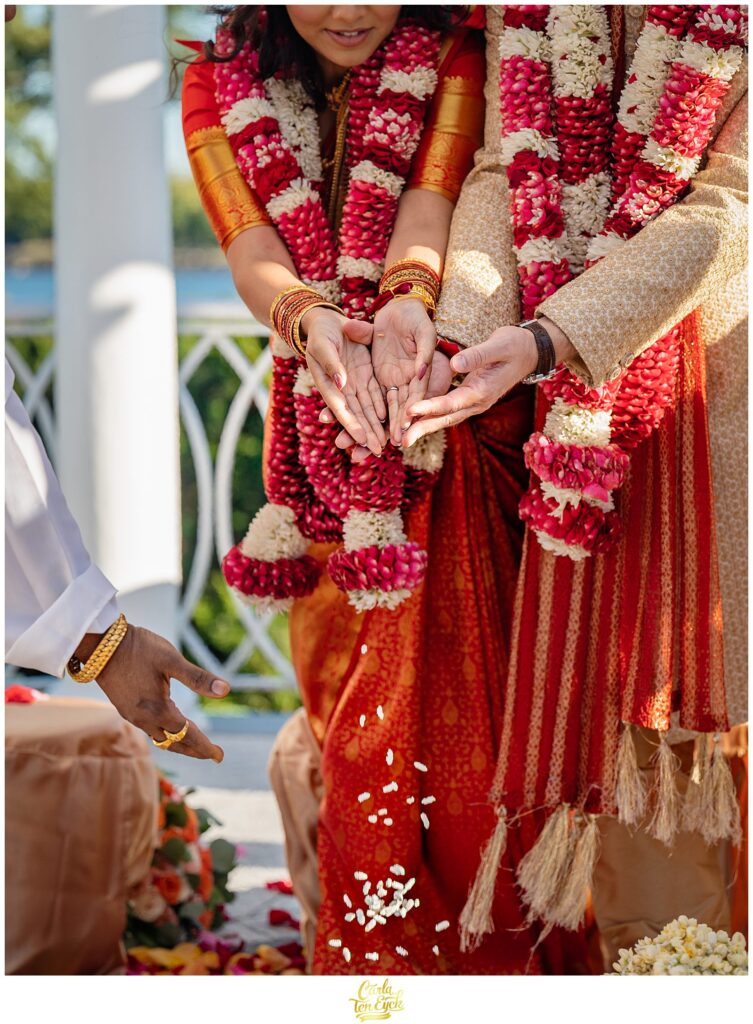 A bride and groom perform Hindu wedding traditions during during their wedding at the VIP Country Club in New Rochelle NY