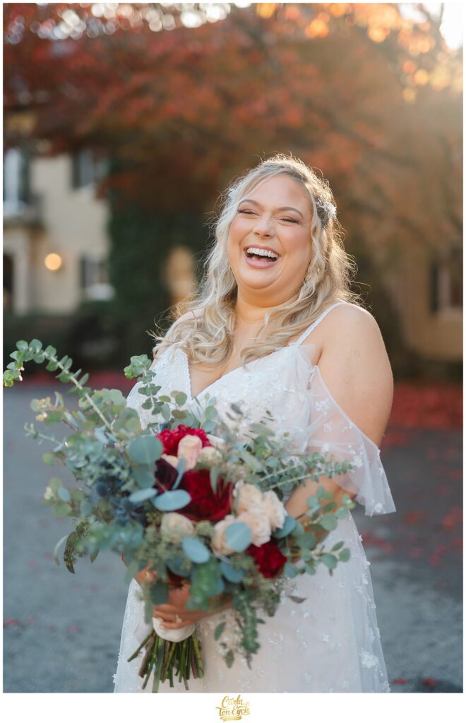 A beautiful bride laughs during her photos at her  autumn lord Thompson Manor wedding in Thompson CT