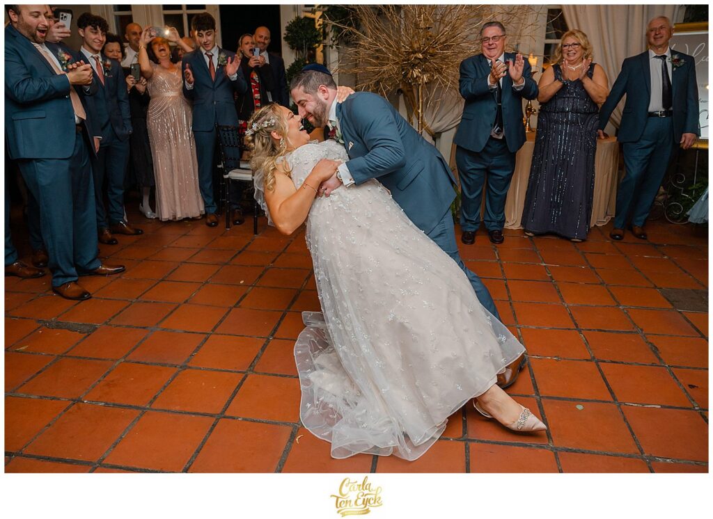 A couple dips during their first dance at their  autumn lord Thompson Manor wedding in Thompson CT