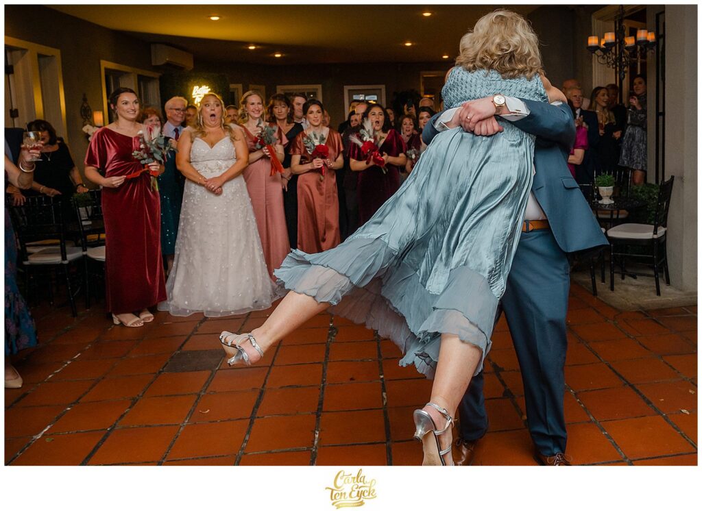 A groom swings his Mom on the dance floor during his  autumn lord Thompson Manor wedding in Thompson CT