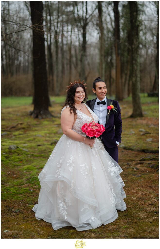 A couple poses for photos at their colorful wedding at Lord Thompson Manor in Thompson CT