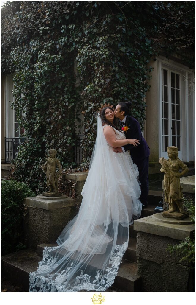 A bride and groom kiss after their colorful wedding at Lord Thompson Manor, in Thompson CT