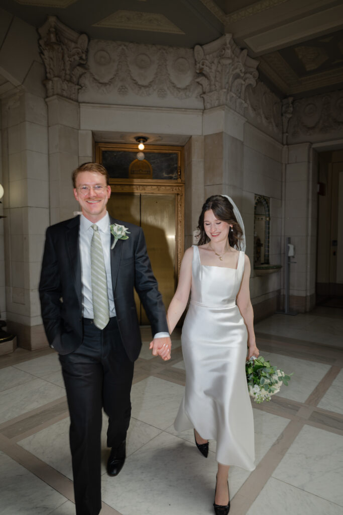 A bride and groom celebrates after their Hartford City Hall elopement with an editorial style photo