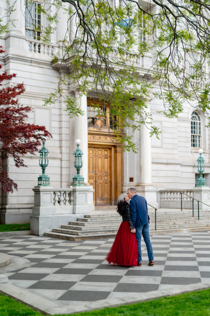A couple kisses outside the iconic Hartford City Hall elopement with the beautiful checkered floor