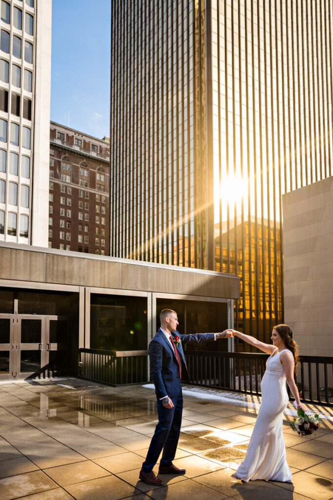 A couple dances in the afternoon glow of the Gold Building after elopement in Hartford City Hall.