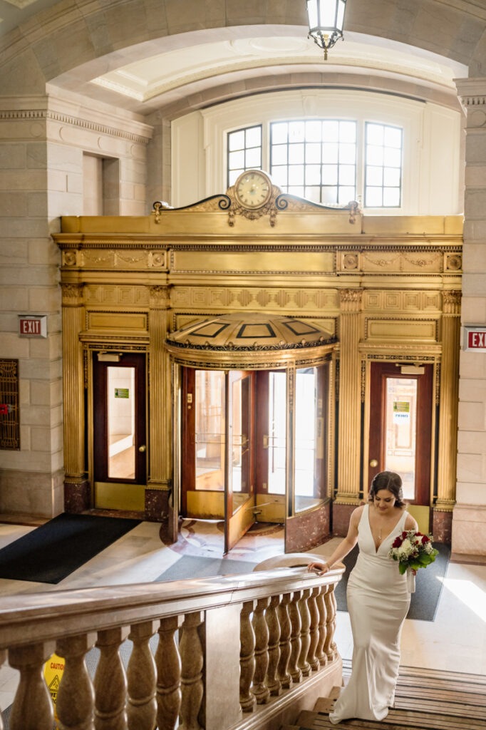 A bride ascends the stairs after her elopement in Hartford City Hall in Hartford CT.