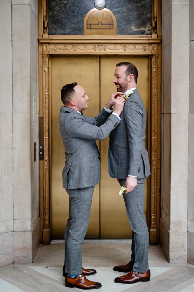 Two grooms prepare for their elopement at Hartford City Hall in Hartford CT.